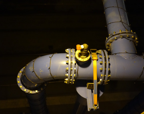 Photo of a pipe branching with bright shiny fittings